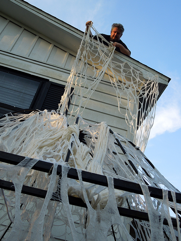 HowToHauntYourHouse_shawn_roof_webs.jpg